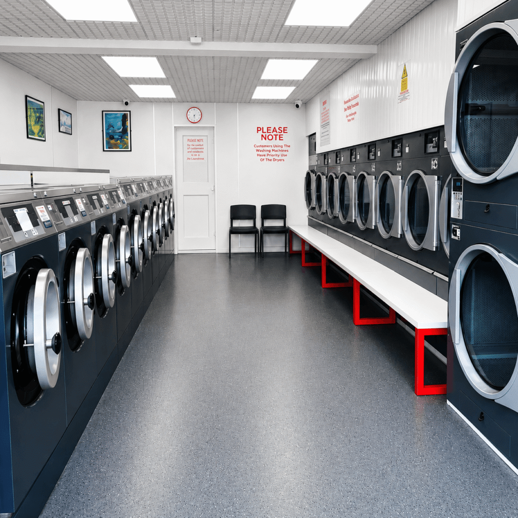 Clean self-service launderette interior with washing machines and tumble dryers at Beauchamp Laundry Service in Handsworth Wood